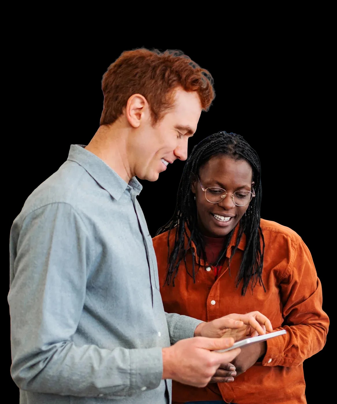 Two colleagues smiling over a tablet
